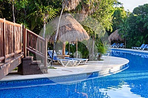 Outdoor resort swimming pool area. Riviera Maya, Cancun, Mexico