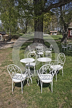 Outdoor restaurant background, metal white chairs and tables