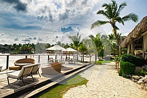 Outdoor restaurant at the beach. Cafe on the beach, ocean and sky. Table setting at tropical beach restaurant. Dominican