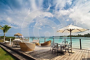 Outdoor restaurant at the beach. Cafe on the beach, ocean and sky. Table setting at tropical beach restaurant. Dominican