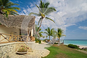 Outdoor restaurant at the beach. Cafe on the beach, ocean and sky. Table setting at tropical beach restaurant. Dominican