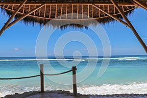 Outdoor restaurant at the beach. Cafe on the beach, ocean and sky. View to beach from bar in Bali, Indonesia. Relaxing on remote