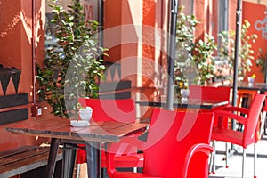 Outdoor restaurant with red tables and chairs