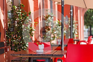 Outdoor restaurant with red tables and chairs