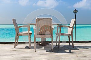 Outdoor restaurant terrace with furniture over sea