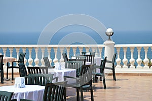 Outdoor restaurant terrace with table over sea