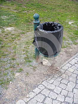 Outdoor rubish bin in a park photo