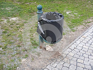 Outdoor rubish bin in a park photo