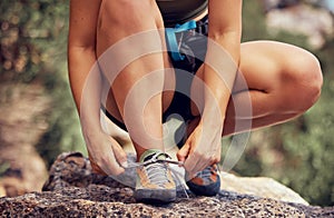 Outdoor runner, tie fitness shoes and sports woman start cardio workout in los angeles forest. Athlete ready to exercise