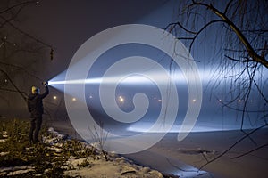 Outdoor searching with flashlight at night.