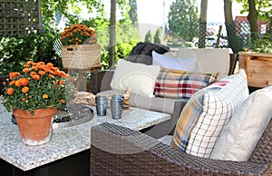 Outdoor seating arrangement around a gas fire pit table in the fall