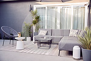 Outdoor Seating And Garden Furniture On Patio Of Contemporary Home