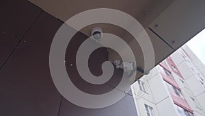 Outdoor Security Camera on a Brick Wall of a House. CCTV camera
