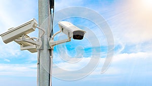 Outdoor security CCTV on the pole with sunlight and blue sky background
