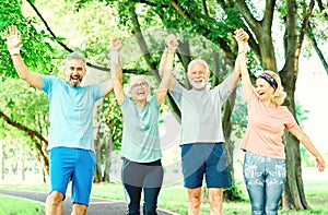 outdoor senior fitness woman man lifestyle active sport exercise healthy fit retirement teamwork together holding hands