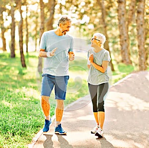 outdoor senior fitness woman man lifestyle active sport exercise healthy fit runner couple running jogging elderly