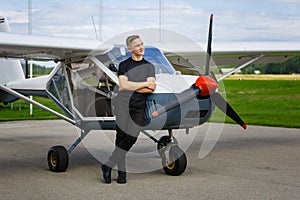 Outdoor shot of young man in small plane cockpit