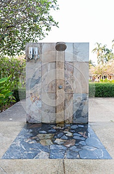 Outdoor shower at swimming pool.  shower cabins behind outdoor swim pool .Outdoor shower area design at the beach, seaside or swi