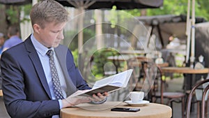 Outdoor Sitting Businessman Reading Book