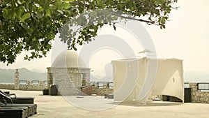 outdoor spa treatment area near the ocean complete with beach chairs, cabana, massage table