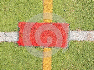 Outdoor stadium. Colorful lines in empty outdoor handball playground, plastic light green surface on ground and white, red and