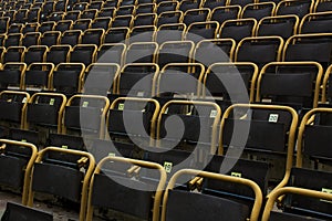 Outdoor stadium seats with yellow frames, straight on view