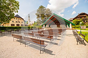 Outdoor stage with rows of wooden benches in the town of St.Gilgen, Austria