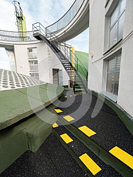 Outdoor stairs of an escape exit in a factory. Yellow markings on the floor