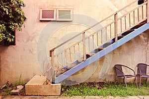 Outdoor stairway and blue colour with wall texture on vintage style picture