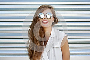 Outdoor street fashion portrait of stylish woman in sunglasses