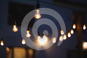 outdoor string lights hanging on a line in backyard.