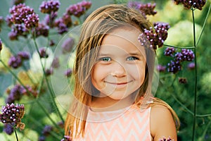 Outdoor summer portrait of adorable little girl of 3 or 4 years old