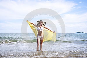 Outdoor summer portrait of the front image of beautiful girls in a sexy bikini standing on the beach in summer. sexy body. concept