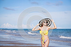 Outdoor summer portrait of the front image of beautiful girls in a sexy bikini standing on the beach in summer. sexy body. concept