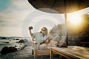 Outdoor summer smiling lifestyle portrait of pretty young woman having fun in with camera travel photo of photographer Making