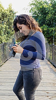 Outdoor summer smiling lifestyle portrait of pretty young woman having fun in the city of Lima taking pictures