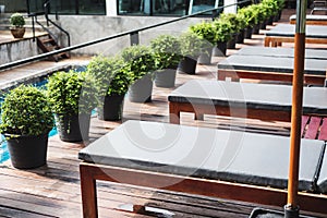 Outdoor sunbathing deck chair at resort swimming pool