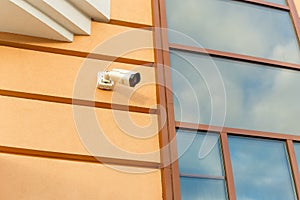 Outdoor surveillance camera on the facade of the building. The concept of safety, security and law and order.