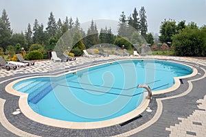 Outdoor swimming pool mountain hotel pool resort chair pool lounge chair relax mountains forest resort. Sunbed mountain
