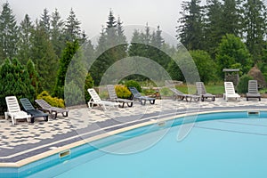 Outdoor swimming pool mountain hotel pool resort chair pool lounge chair relax mountains forest resort. Sunbed mountain