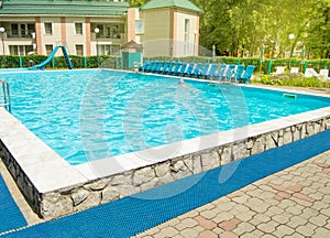 Outdoor swimming pool in the recreation area on the territory of a luxury hotel in the resort, the concept of summer idyllic