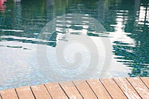 Outdoor swimming pool with wooden deck at resort