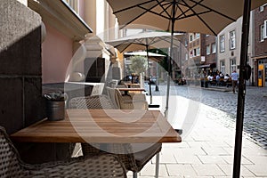 Outdoor table and chair without people in front of cafe, bar, and restaurant in walking street old town DÃÂ¼sseldorf, Germany.