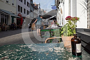 Outdoor table and chair without people in front of cafe, bar, and restaurant in walking street old town DÃÂ¼sseldorf, Germany.