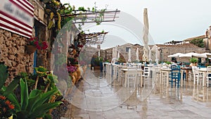 Outdoor table of a restaurant in Marzamemi city in Sicily coast