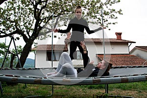 Outdoor teenagers activity on trampoline