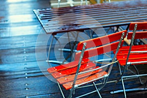 Outdoor terrace chairs and tables in raindrops