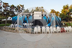 Outdoor theater podium with trees in background in northern photo