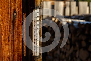 Outdoor thermometer on the wall of the house.