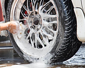 Outdoor tire car wash with sponge